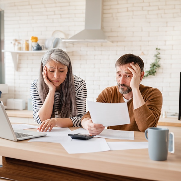 a group of people sitting at a table with a laptop
